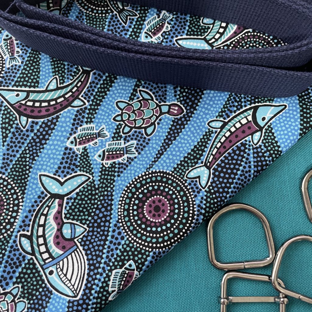Blue and turquoise sea-themed batik fabric, turquoise cotton canvas, navy blue strapping and grey buckles.