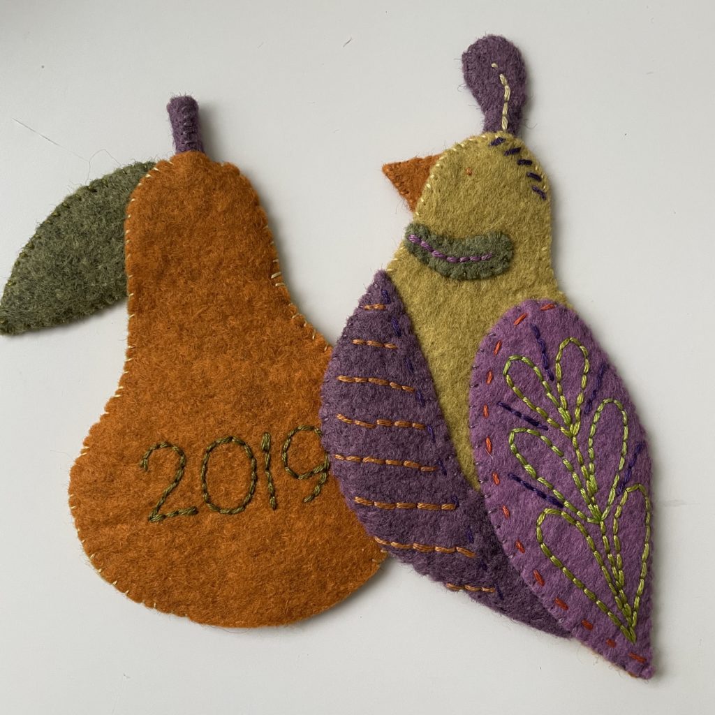 Embroidered felt partridge and pear ornaments.